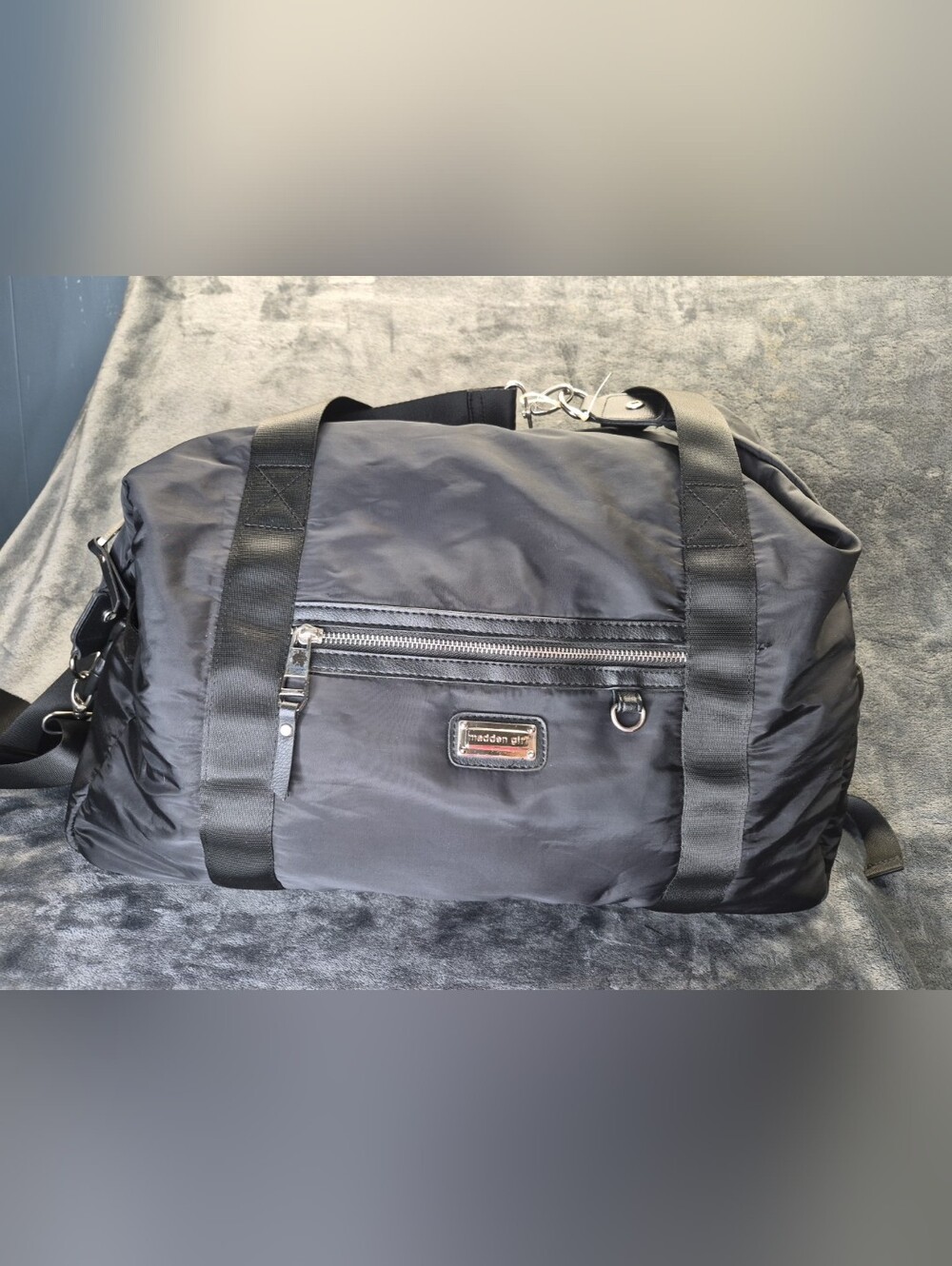 This is a Madden Girl black nylon overnight travel duffel bag 18x15x7"